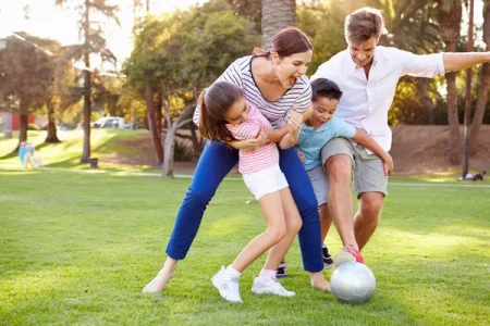 depositphotos 50697379 stock photo family playing soccer in park