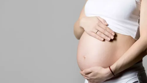 pregnant woman touching her belly 1200x675 1